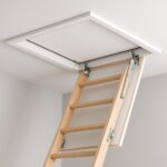 Wooden loft ladder extending from ceiling hatch